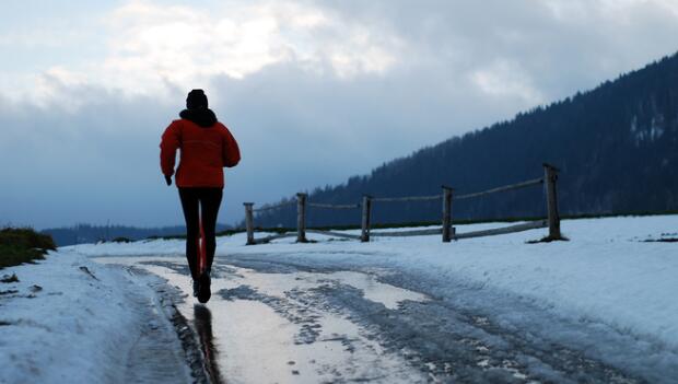 Runner on Winter Snowy Road